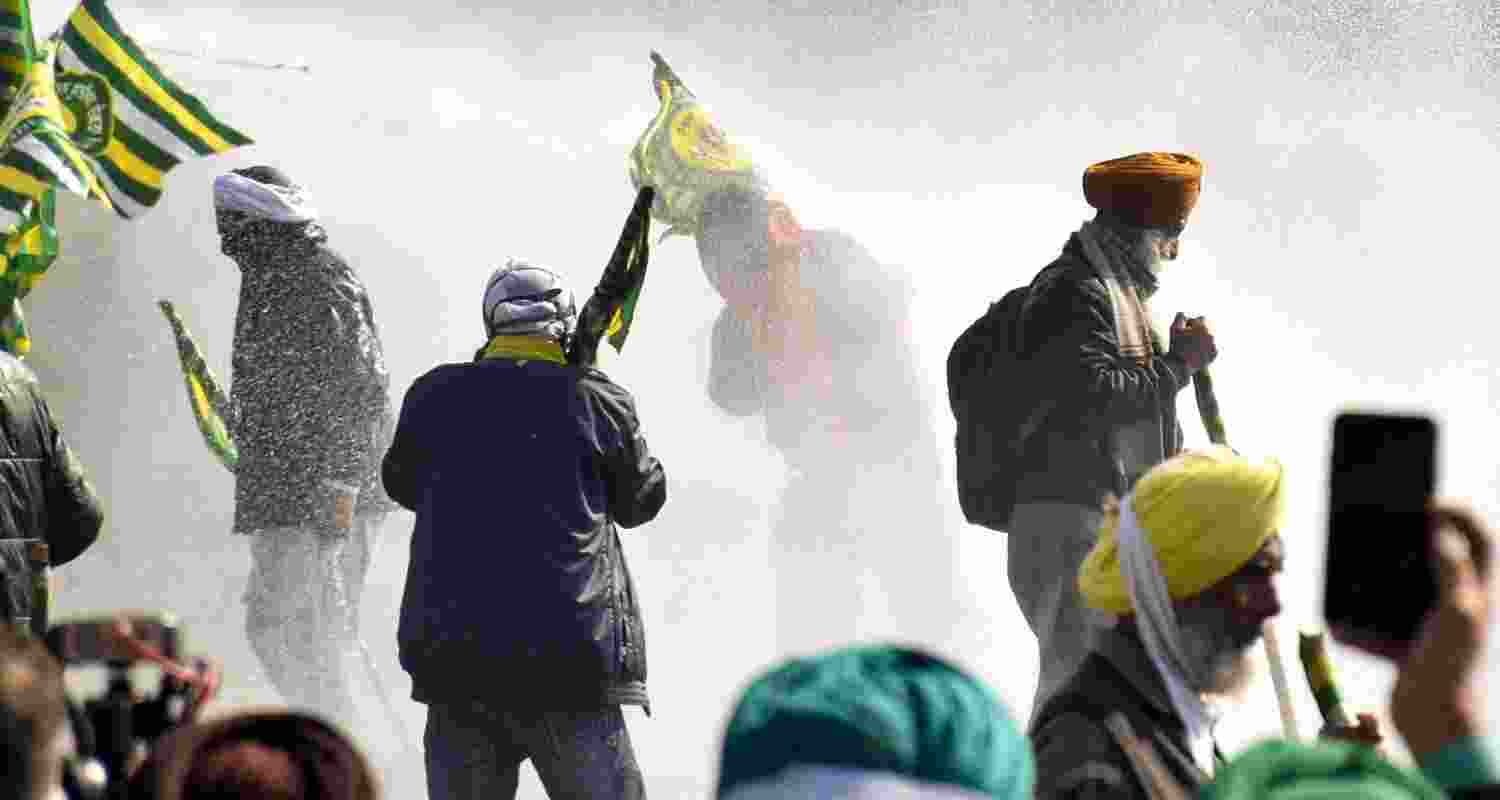 Security personnel use water cannons to disperse farmers agitating at Shambhu border, in Patiala district, Punjab, Saturday.