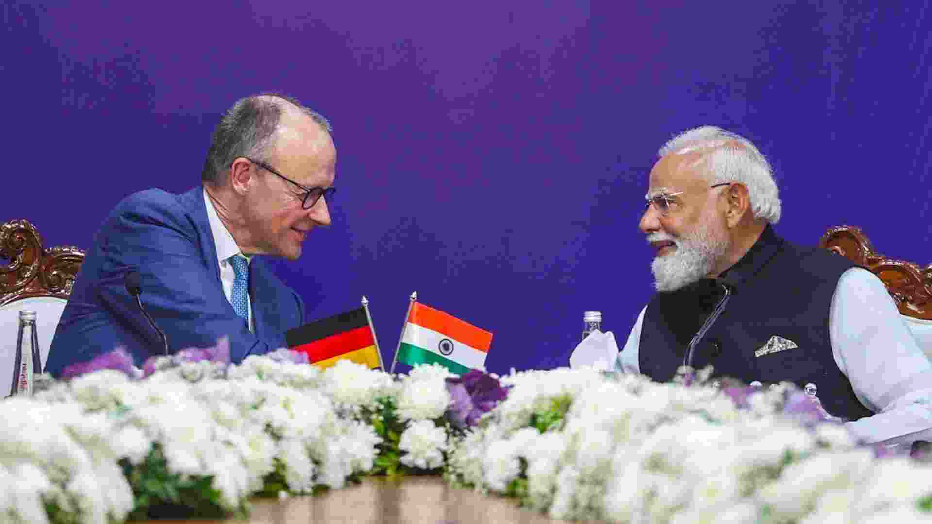 Prime Minister Narendra Modi and German Chancellor Friedrich Merz during the India-Germany CEOs Forum at Mahatma Mandir Convention Centre, in Gandhinagar, Gujarat. 