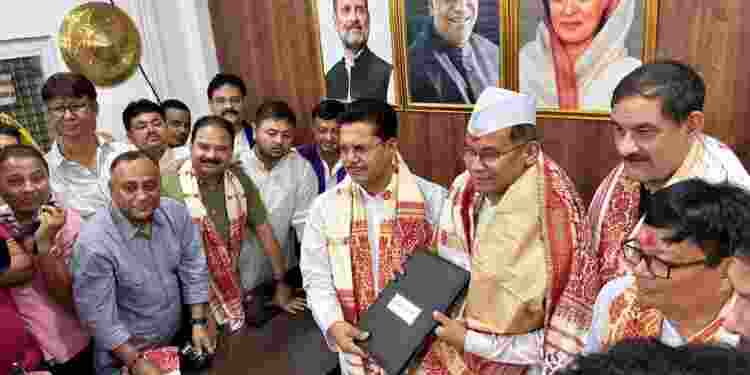 The official handover ceremony being held at the Assam Congress headquarters in Guwahati.