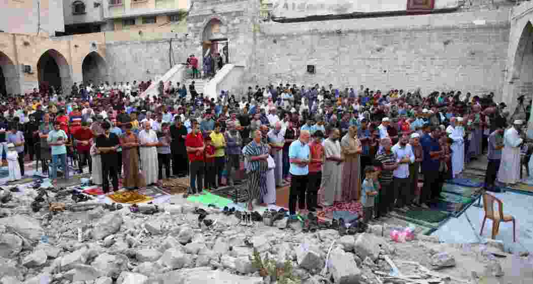 Palestinians performing the Eid al-Adha morning prayer on the first day of the Muslim holiday in the courtyard of Gaza City’s Omari Mosque, which was heavily damaged in Israel’s military offensive.