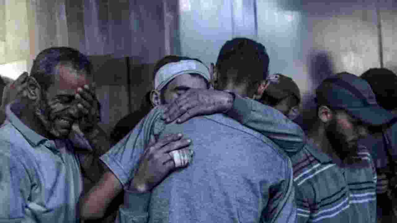 A Palestinian man mourns at the Al-Shifa hospital in Gaza City after an Israeli airstrike in July 2025.