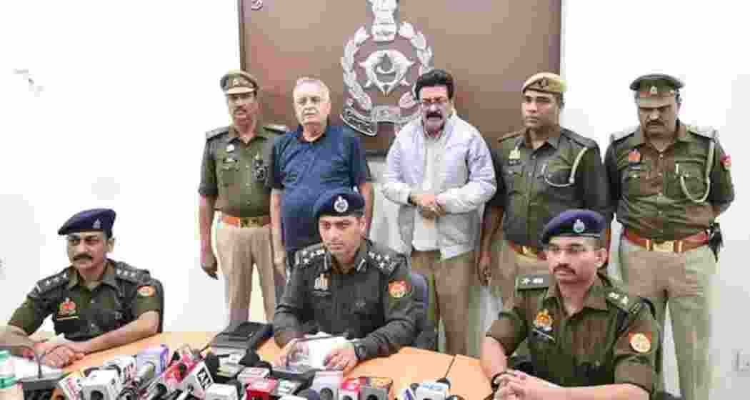 Anil Katiyal (in blue T-shirt) and his associate Vinod Kapoor (in a jacket) were arrested by the police for impersonation and attempting to influence an investigation.