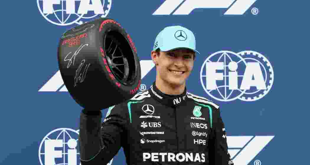 Mercedes' George Russell celebrates after qualifying in pole position.