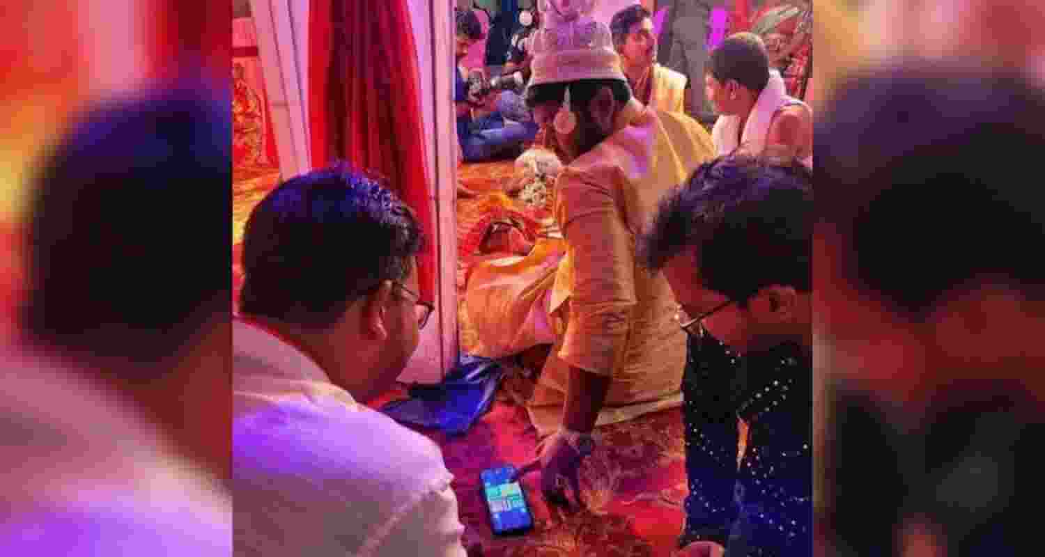 The groom playing ludo during the wedding.