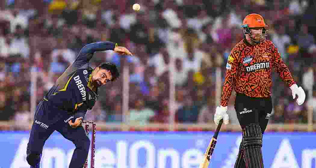 Gujarat Titans' Rashid Khan bowls a delivery during the Indian Premier League (IPL) 2025 cricket match between Gujarat Titans and Sunrisers Hyderabad, in Ahmedabad, Friday, May 2, 2025. 