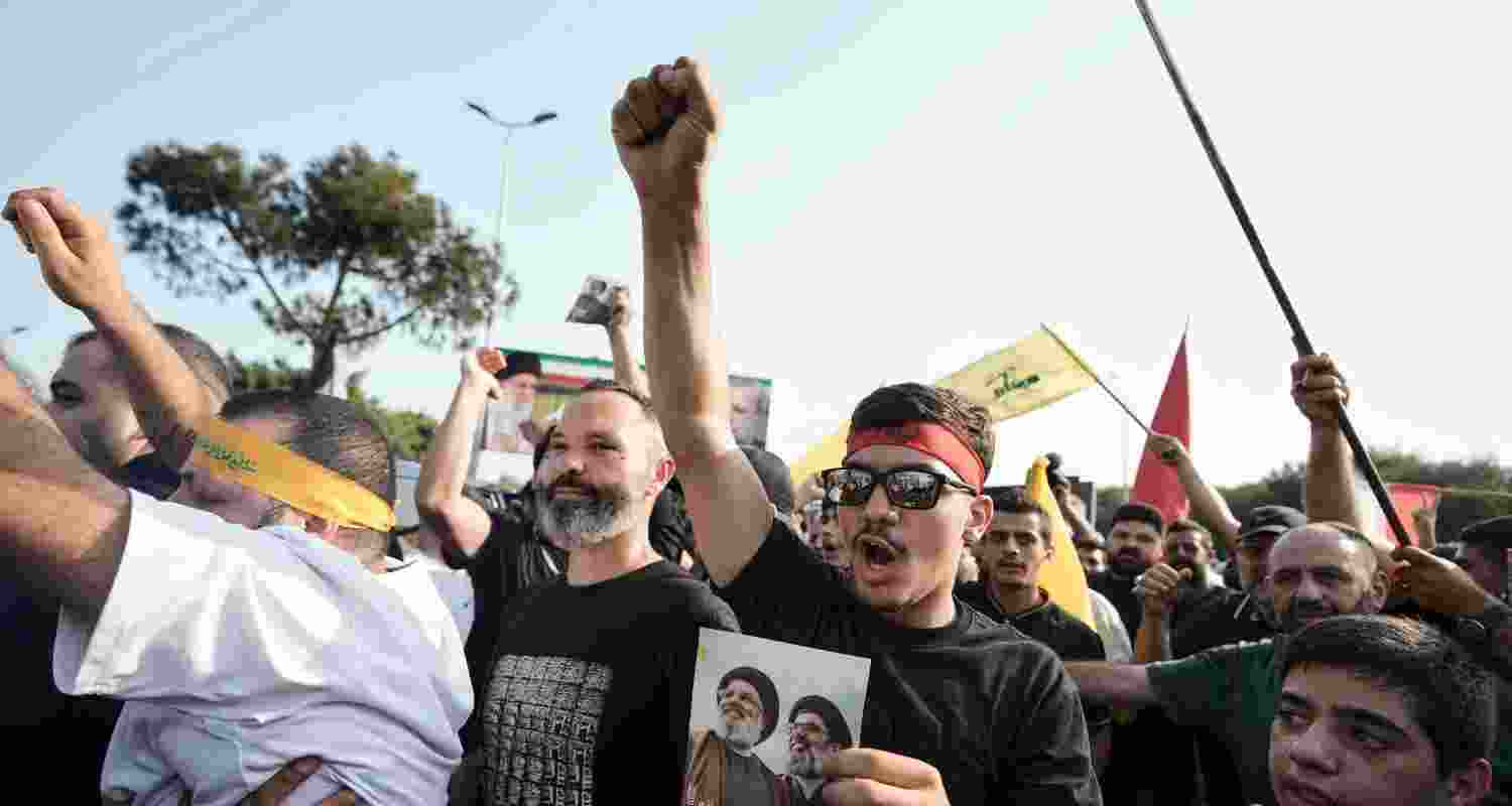 Hezbollah supporters chant slogans as they gather to welcome Ali Larijani, head of Iran’s National Security Council, outside Rafik Hariri International Airport in Beirut, Lebanon.