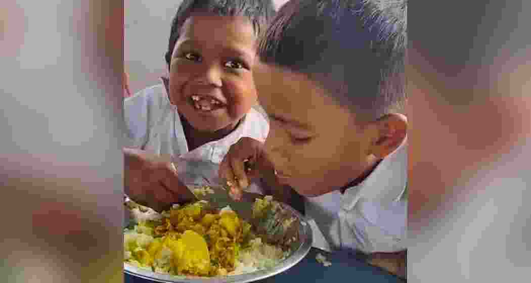 Soleman Sheikh and Sandeep Saha of Malda’s Olitola Primary School share a mid-day meal.