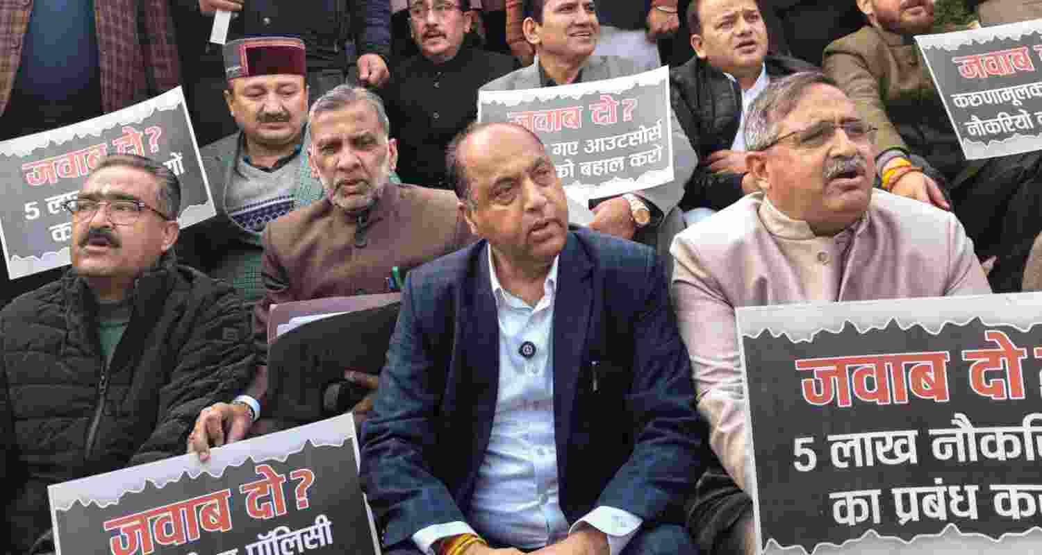 Leader of Opposition in Himachal Pradesh Assembly Jai Ram Thakur with BJP MLAs protest outside the Vidhan Sabha during the Winter session, in Tapovan, Dharamsala, Friday. 