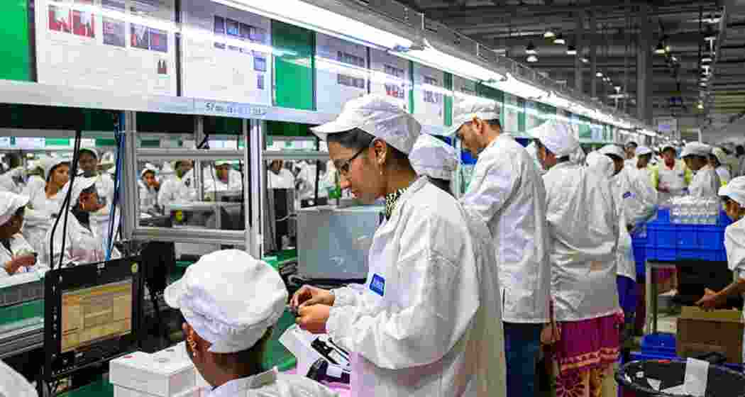 Employees test mobile phones on an assembly line at the Rising Stars Mobile India Pvt. Ltd. plant, a unit of Foxconn Technology Co., in Sriperumbudur, Tamil Nadu, India.