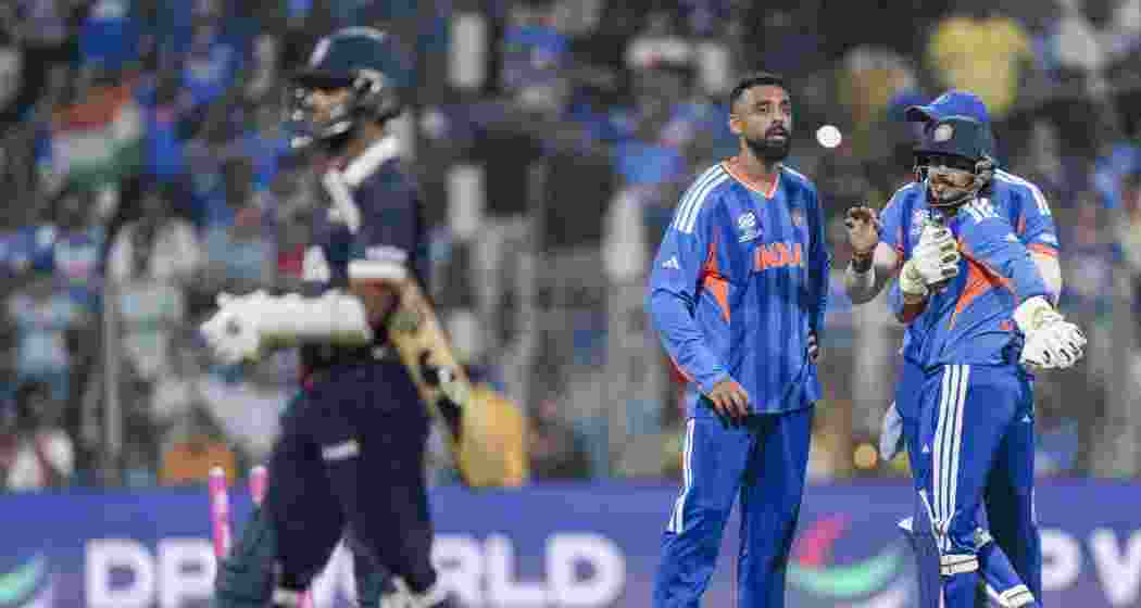 India's Varun Chakravarthy with teammates celebrates the dismissal of USA's Milind Kumar during the ICC Men's T20 World Cup 2026 cricket match between India and USA, at the Wankhede Stadium, in Mumbai on Saturday.