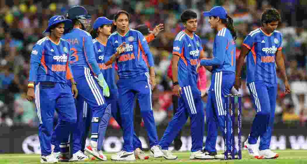 Indian players celebrate a wicket during the rain-hit first Women’s T20I against Australia in Sydney, where India secured a 21-run victory under the DLS method.