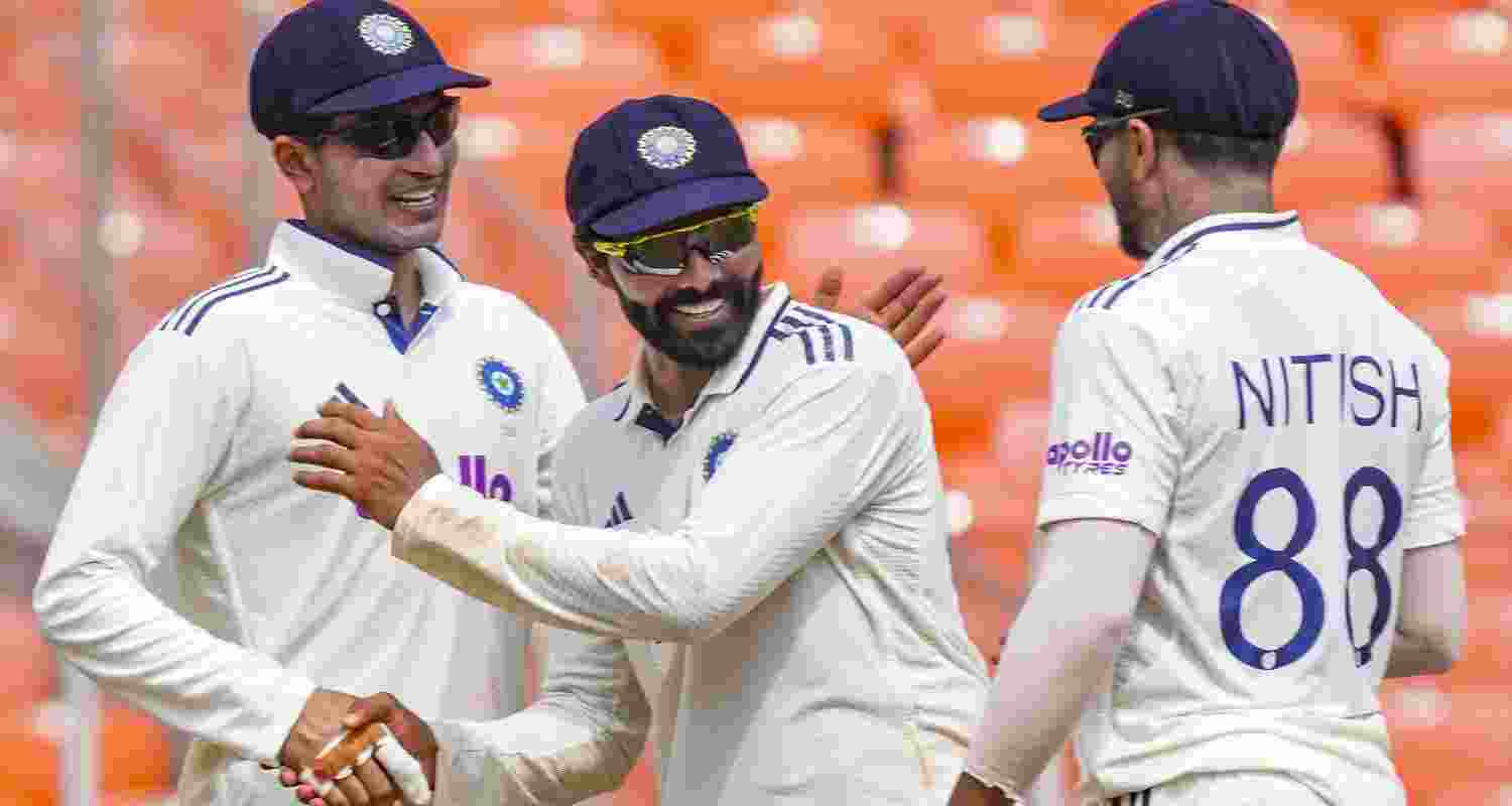 India's captain Shubman Gill celebrates with teammates Ravindra Jadeja and Nitish Kumar after India won the first Test cricket match against West Indies, in Ahmedabad, Gujarat, Saturday. 