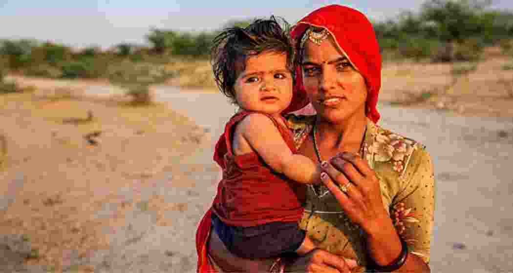 A woman holds her infant.