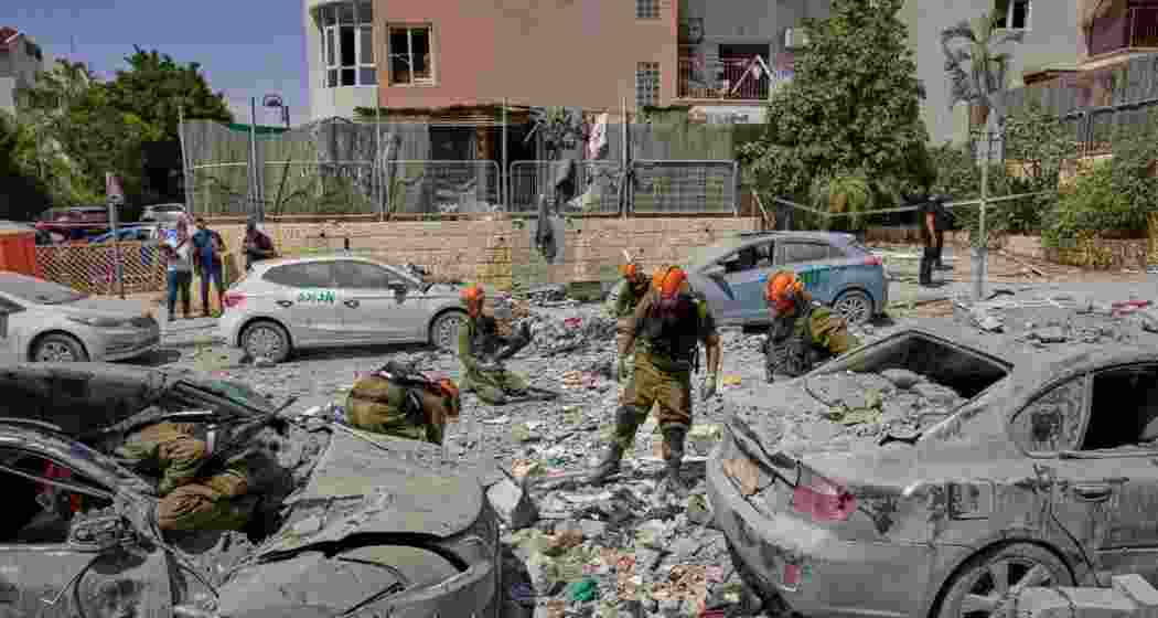 Israeli soldiers work amid the rubble of residential buildings destroyed by an Iranian missile strike that killed several people, in Beersheba, Israel, on Tuesday.