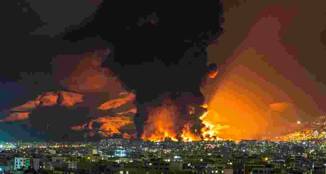 Smoke and flames rise at the site of airstrikes on an oil depot in Tehran. 