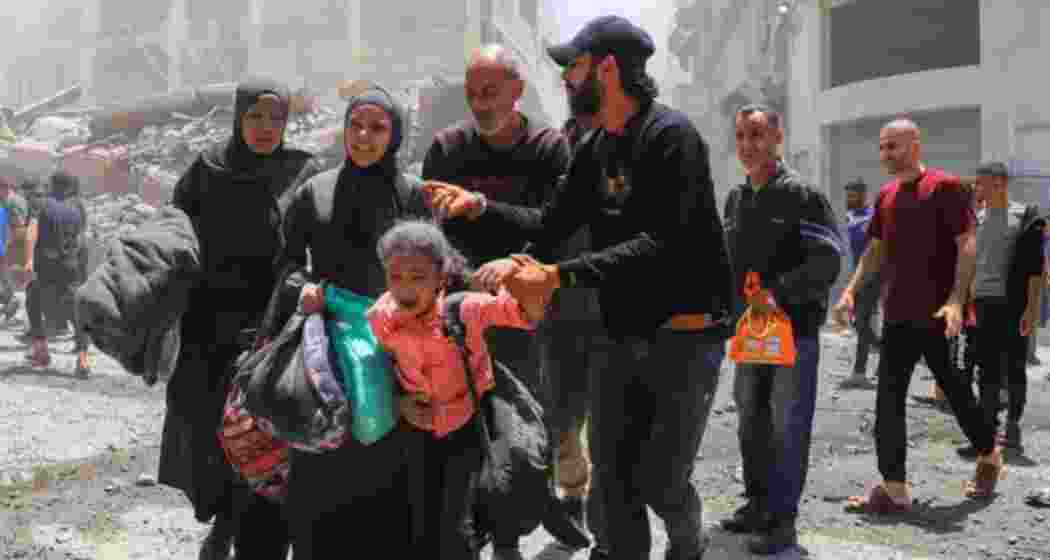 Palestinians evacuate in the aftermath of an Israeli strike on a house, in Gaza City, May 30, 2025 