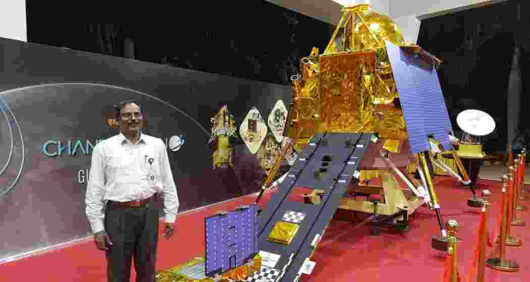ISRO Chairman V. Narayanan poses near a model of the Chandrayaan-3 moon lander. 