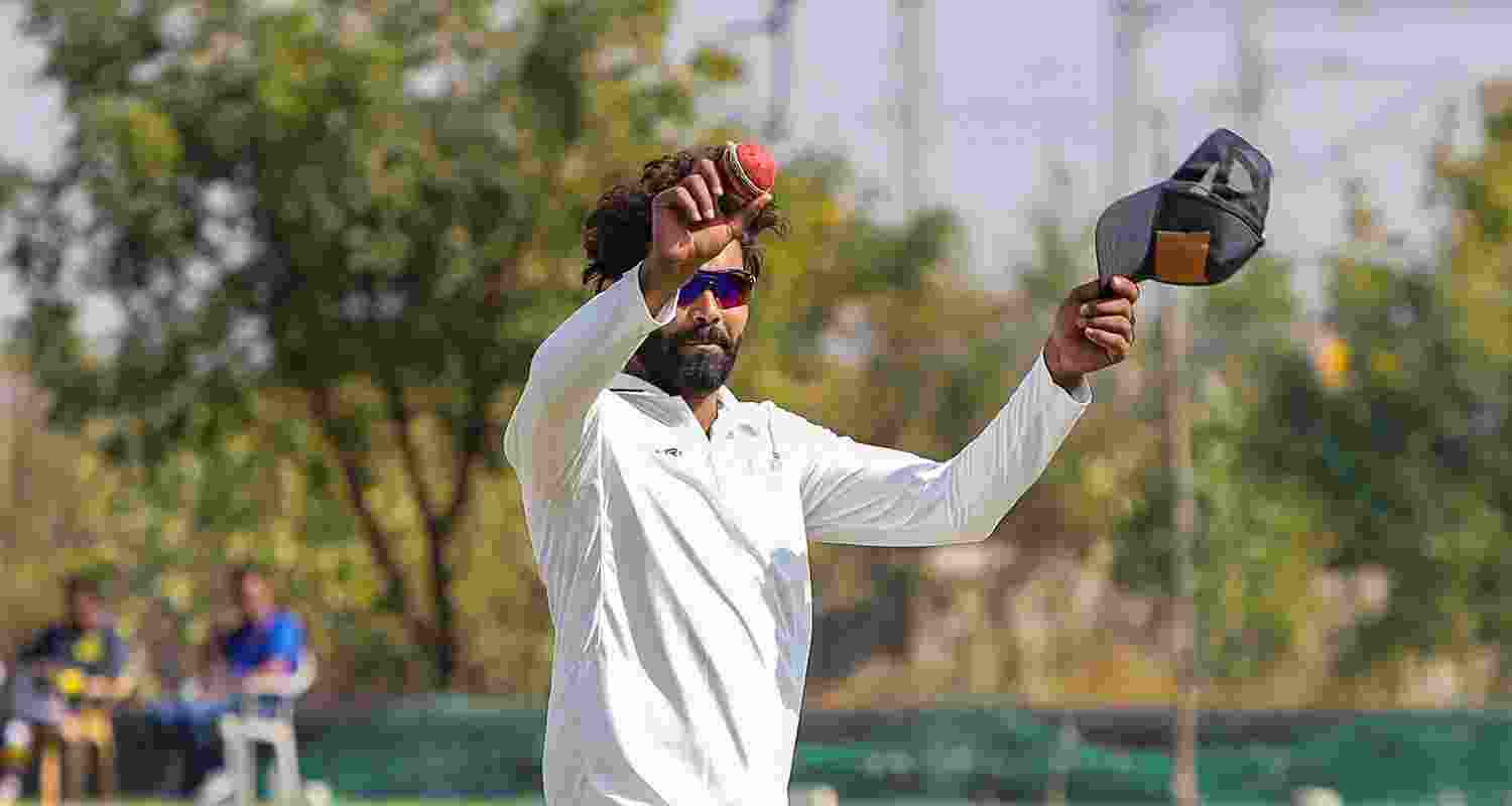 Saurashtra's Ravindra Jadeja celebrates after taking seven wickets at the end of Delhi's second innings on the second day of a Ranji trophy cricket match between Delhi and Saurashtra, at the Niranjan Shah Stadium, in Rajkot.