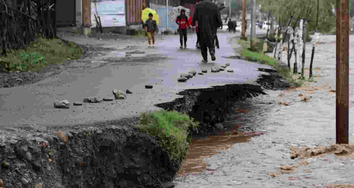 Cloudbursts and heavy rain triggered flash floods and landslides across Jammu and Kashmir, disrupting roads as the IMD warned of more rain and storms.