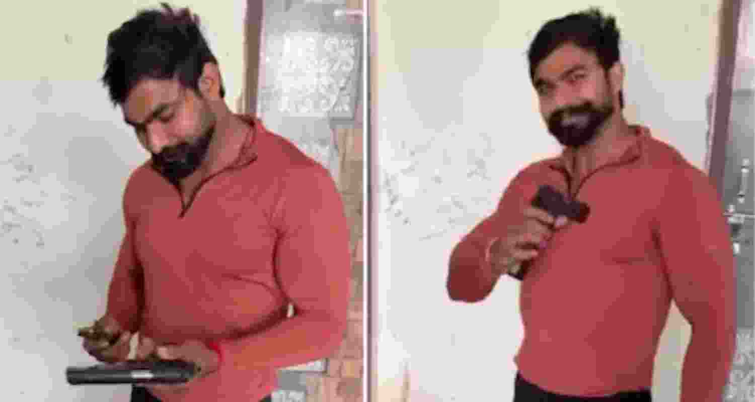 Screengrab from the video where Pawan is seen handling a pistol while his friend provides instructions on how to load the magazine, at one point saying, “Click the button, it will go inside.” 