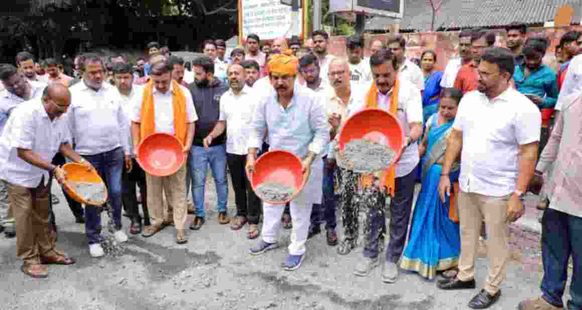 Condemning the Karnataka government's action of making people's lives miserable by not filling potholes in Bengaluru, in Banashankari, under the leadership of Leader of Opposition R Ashoka, BJP workers expressed their anger by filling the potholes on the roads on Wednesday.