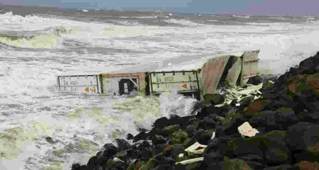 A container from the Wan Hai 503 lies on Vizhinjam beach as Kerala launches a citizen-driven app to report hazardous shipwreck debris along its coast. 65 containers have surfaced so far.