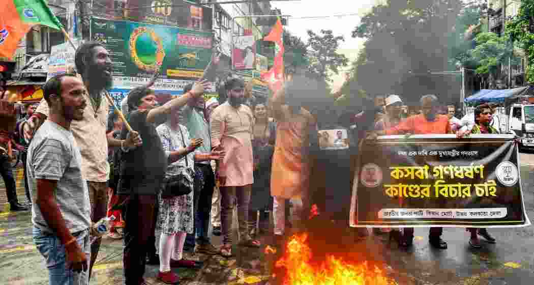 BJP members stage a demonstration against the alleged rape of a student at a law college, in Kolkata, Tuesday.