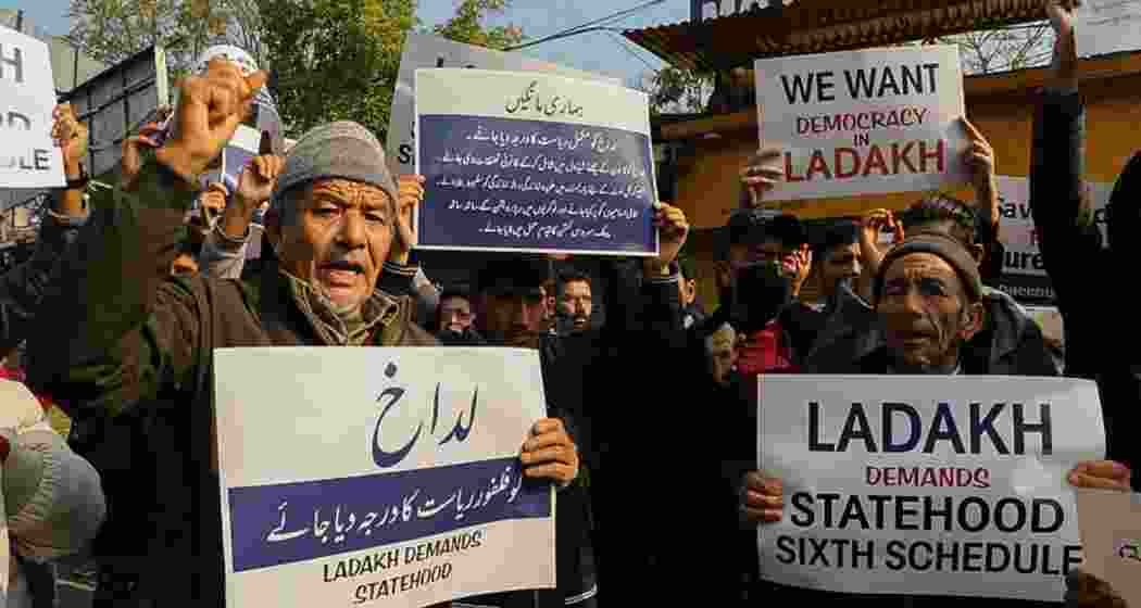 Residents from Ladakh hold placards demanding statehood and other democratic rights for their region during a protest in Leh. 