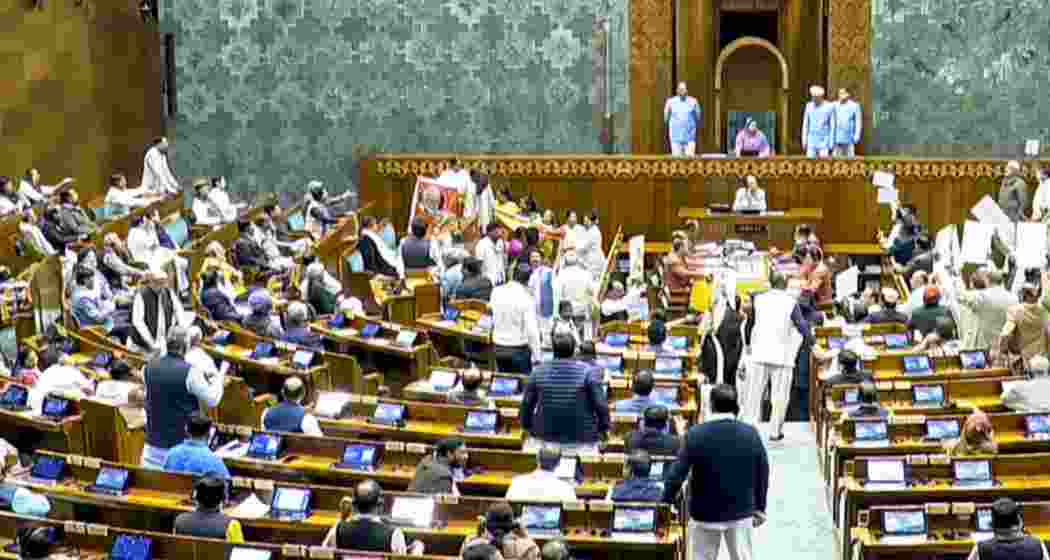 Opposition MPs protest in the Lok Sabha during the Budget session of Parliament, in New Delhi on Wednesday.