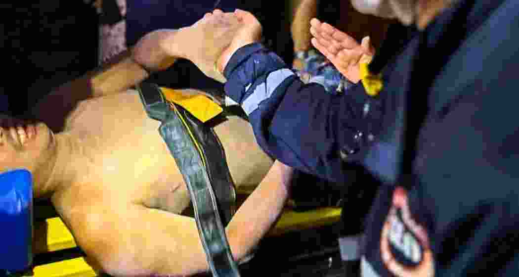 Rescue workers carry an injured man to hospital for treatment in Naypyitaw, Myanmar, on Wednesday, after he was pulled from the rubble of a collapsed hotel—five days after a devastating 7.7 magnitude earthquake struck the country.