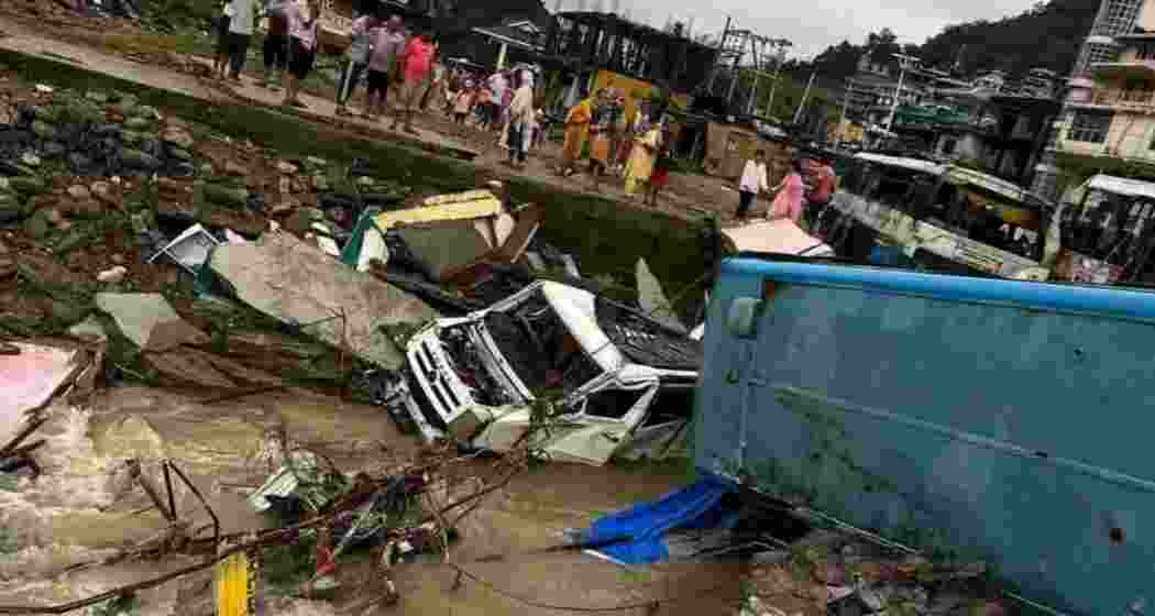 Dharampur bus stand and market submerged, HRTC buses and cars washed away, houses and shops buried under debris.