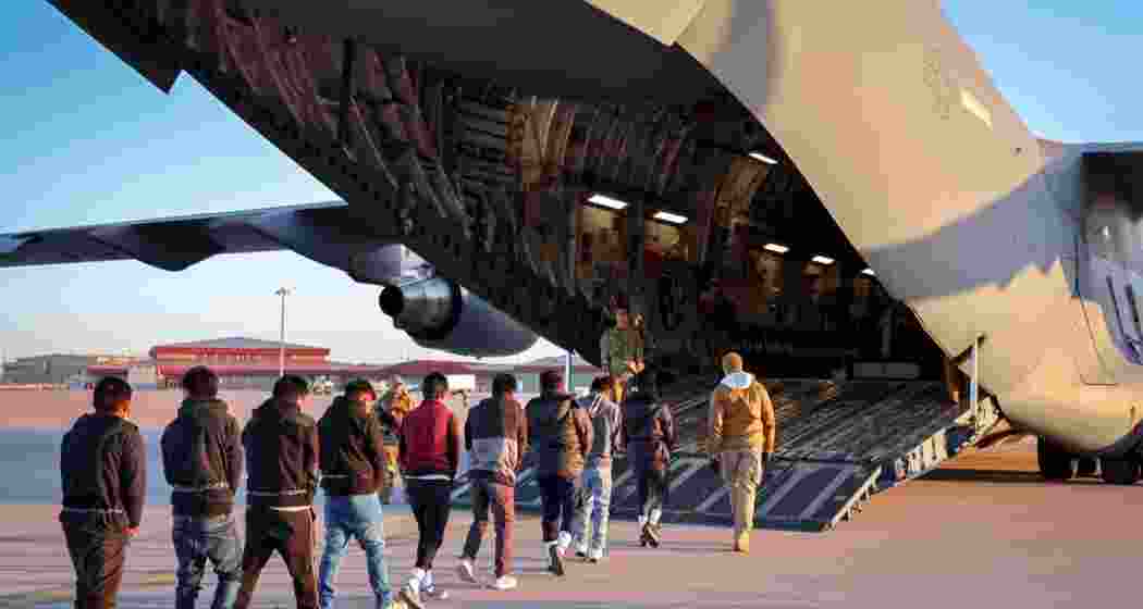 Mexican deportees being escorted to a US Air Force C-17 deportation flight amid intensified border measures under President Trump’s administration. One such flight was denied landing in Mexico, according to officials concerned.