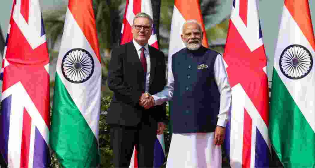 Prime Minister Narendra Modi exchanges a warm handshake with United Kingdom Prime Minister Keir Starmer, at Raj Bhavan, Mumbai. 