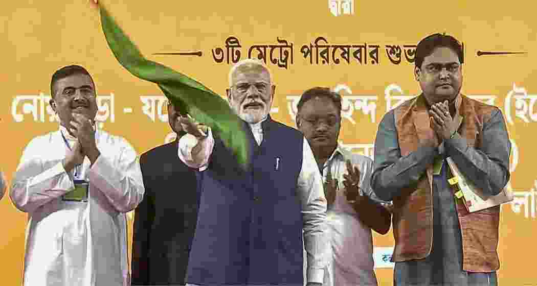 Prime Minister Narendra Modi waves the green flag to inaugurate three new metro routes in Kolkata.