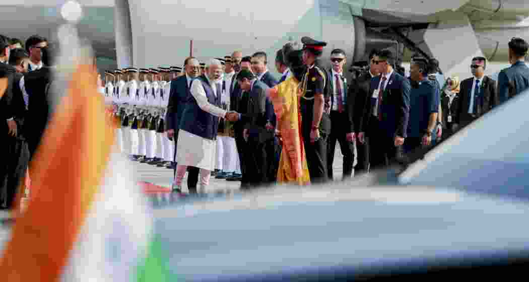 Prime Minister Narendra Modi with his Malaysian counterpart Anwar Ibrahim as the former is welcomed upon arrival at the airport, in Kuala Lumpur, Malaysia on Saturday. (Image: PMO via PTI Photo)