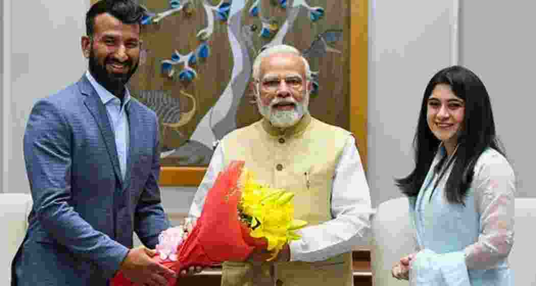 Cheteshwar Pujara (L) and his wife Puja (R) with PM Narendra Modi. 