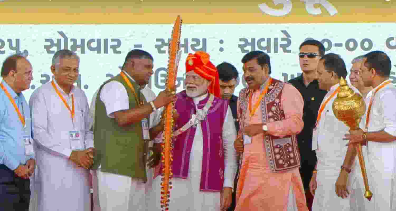 Prime Minister Narendra Modi being with others at a public meeting during the inauguration of Loco Manufacturing Shop and various development projects, in Dahod, Monday.