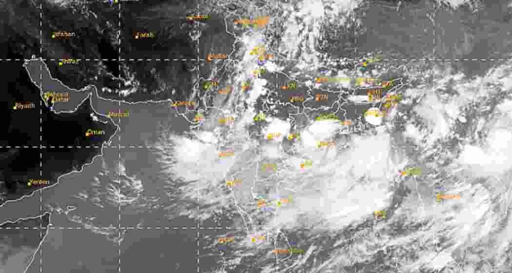 An IMD satellite image shows dense cloud formations associated with a well-marked low-pressure area over the northwest Bay of Bengal, driving an active monsoon spell across central and western India.