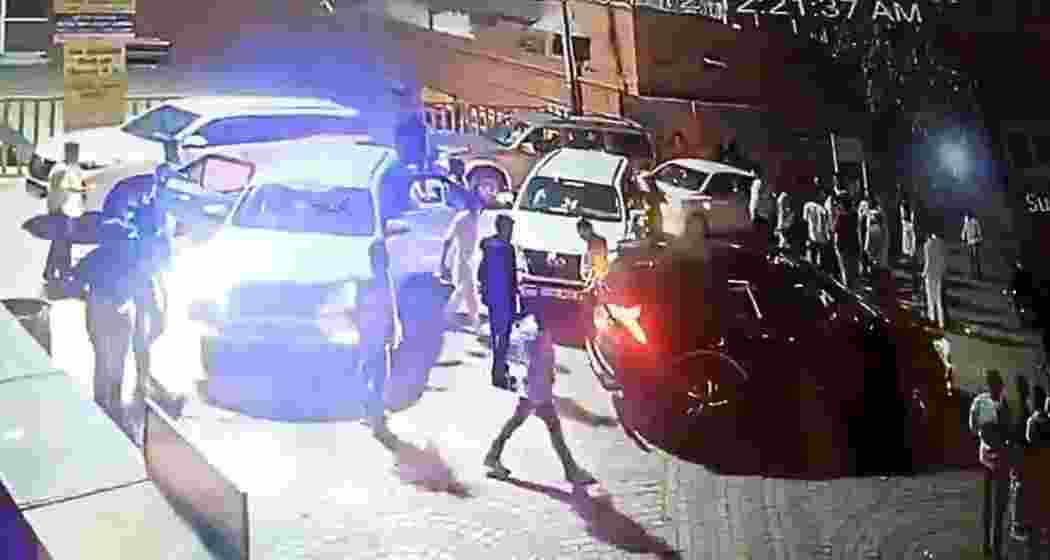 A convoy of vehicles, including some with red beacons, seen at the Mata Tekri temple entrance before a mob allegedly assaulted the priest after being denied entry past midnight.