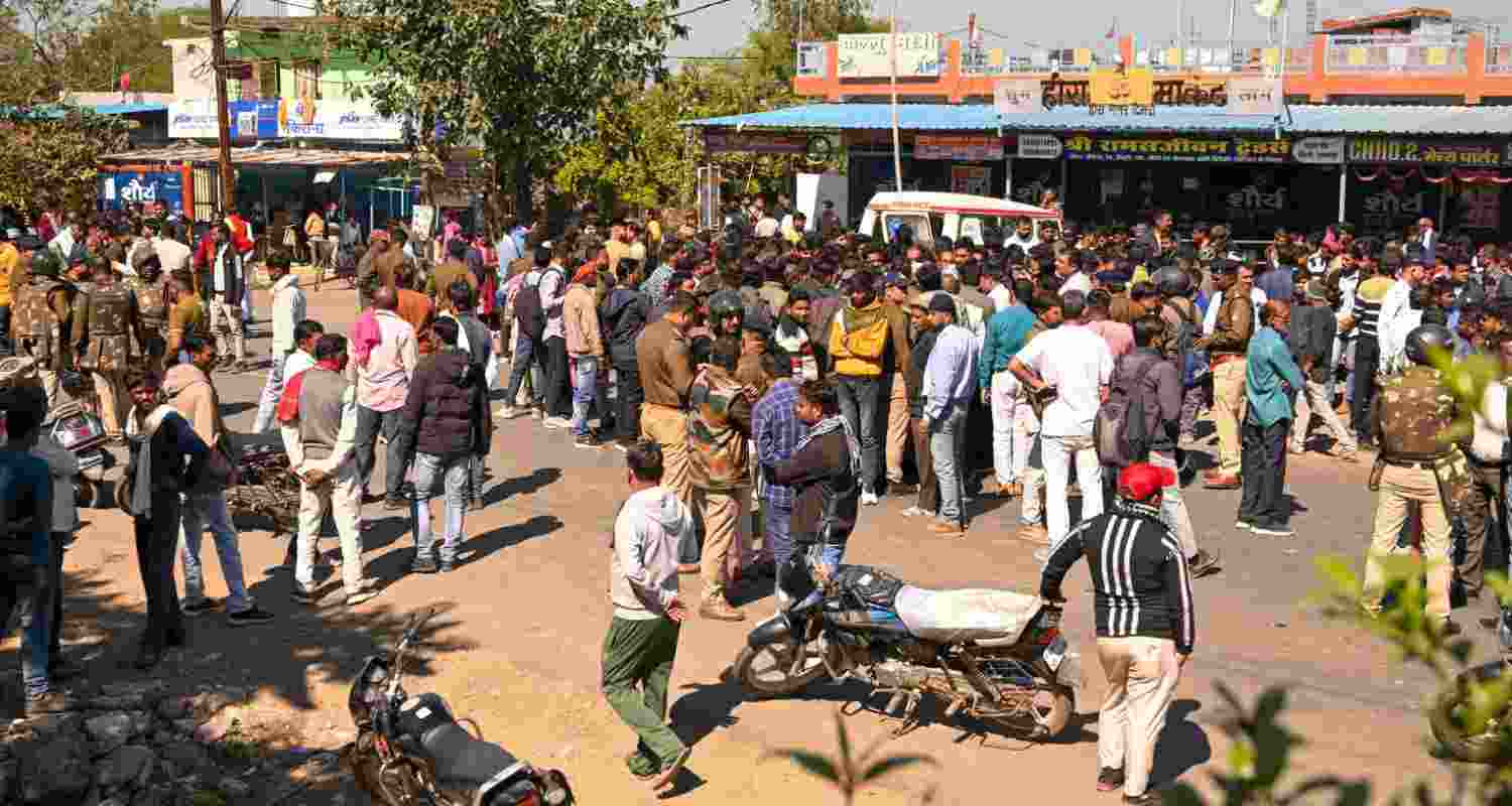 People gather amid heavy security after four men were killed and another person was injured following an attack by a group of people, at Timari village in Madhya Pradesh's Jabalpur district. 