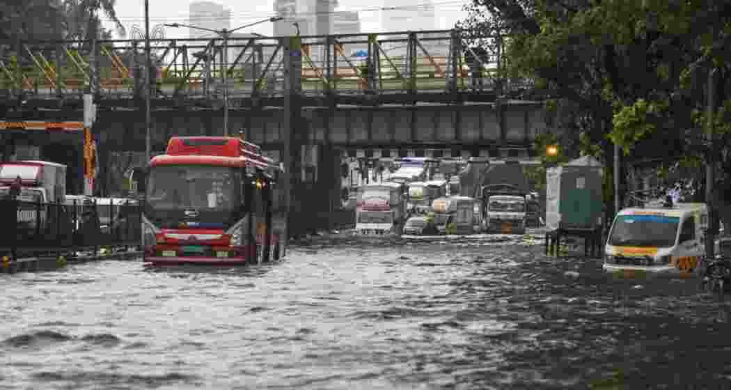 Vehicles move on a flooded road after heavy monsoon rainfall, in Mumbai, Monday.