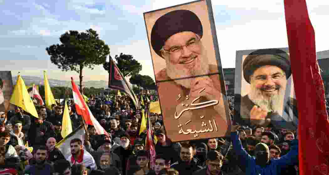 People wave flags and hold posters of Nasrallah ahead of his final journey, gathering in Beirut to pay tribute to the slain Hezbollah leader.