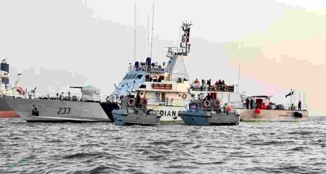 Navy and Coast Guard vessels engage in search and rescue operations near the site of the ferry-Navy craft collision off the Mumbai coast on Thursday.