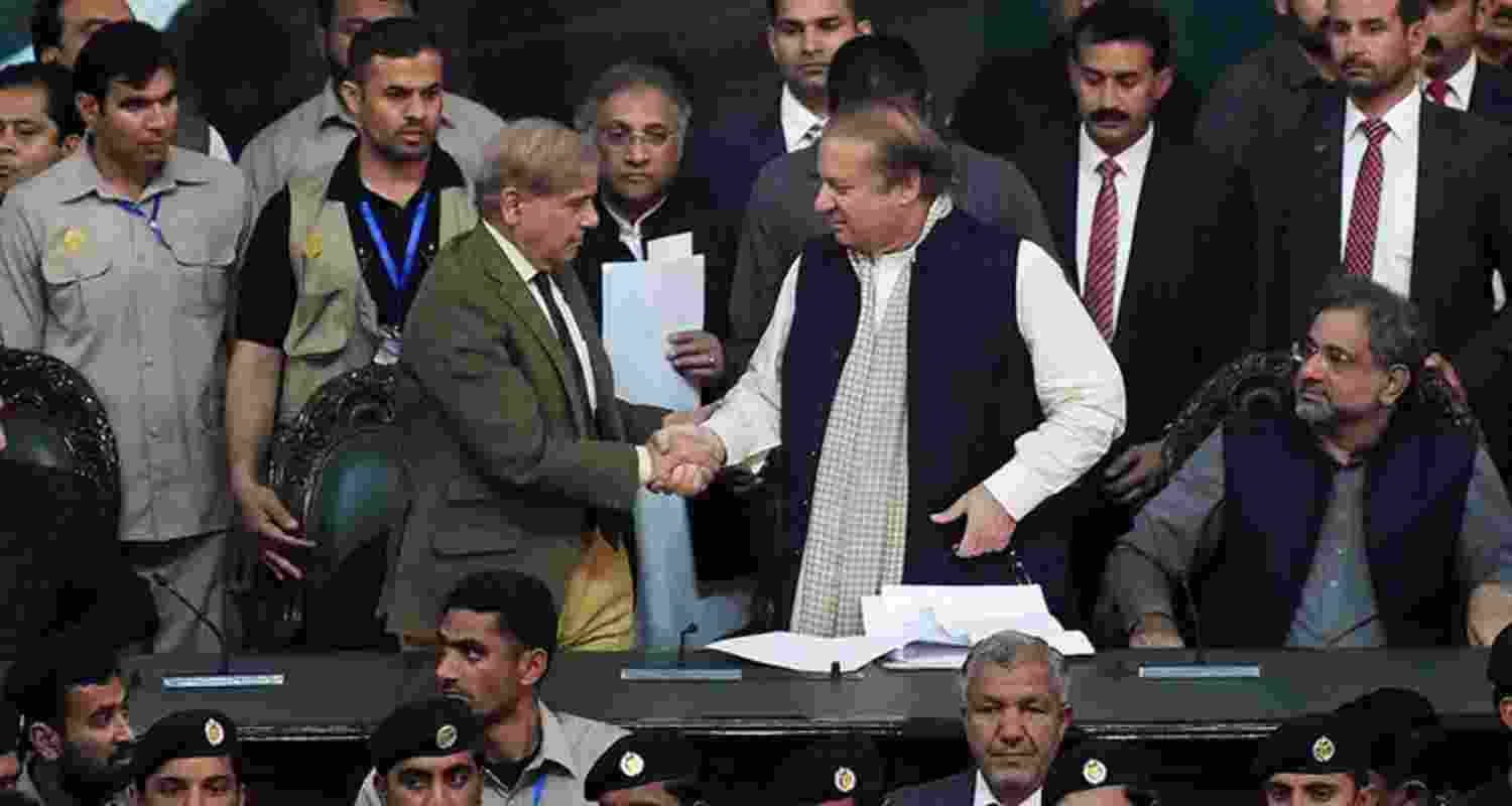 Nawaz Sharif shaking hands with Shahbaz Sharif in Islamabad.