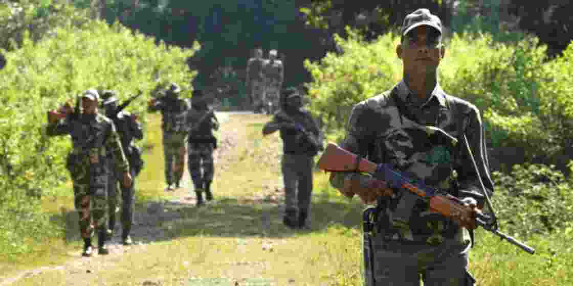 Security personnel patrol dense jungle areas in Chhattisgarh.