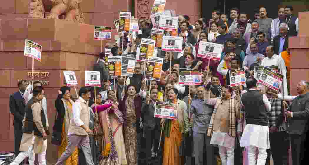  NDA members stage a protest demanding an apology from the opposition Congress for allegedly insulting Ambedkar, at Parliament premises, in New Delhi on Thursday, Dec. 19, 2024.