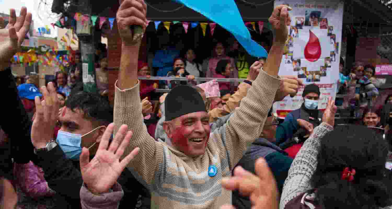 Supporters of Rastriya Swatantra Party celebrate the victory of Ranju Darshana, a candidate for a seat in the House of Representatives in Kathmandu, Nepal, Friday. 