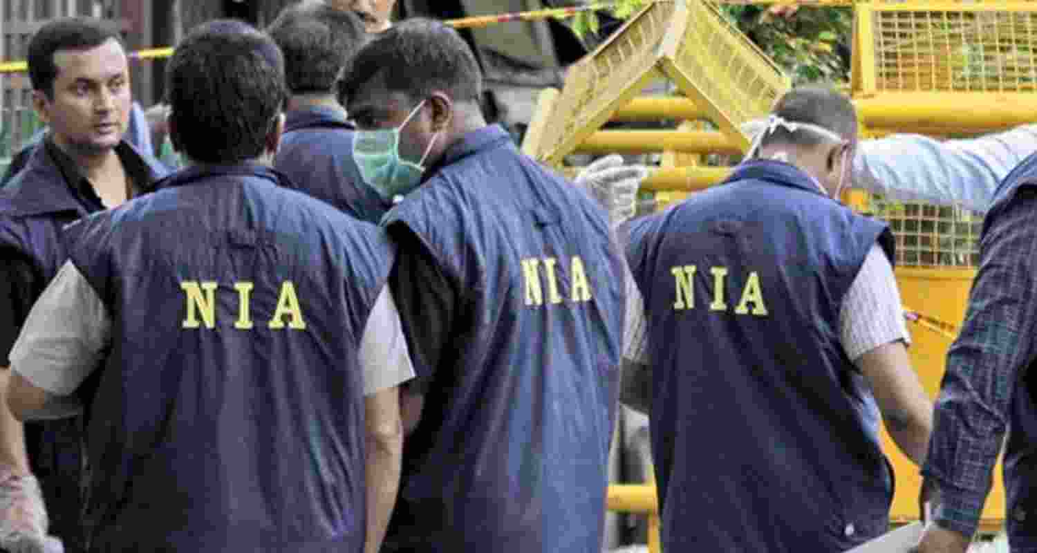NIA personnel during raid. 