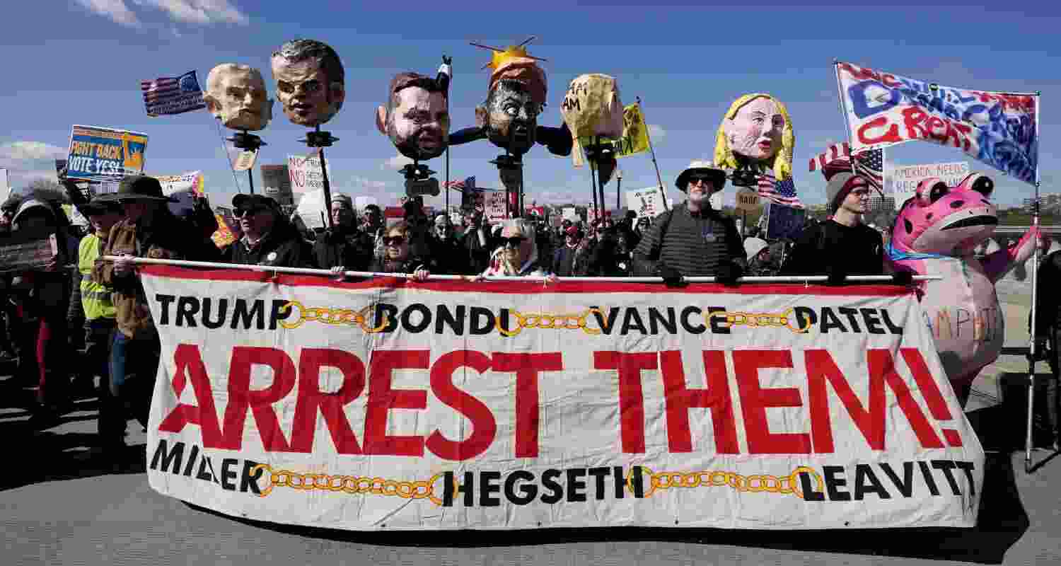 Demonstrators march near the Memorial Bridge during the No Kings protest in Washington, Saturday, March 28, 2026.