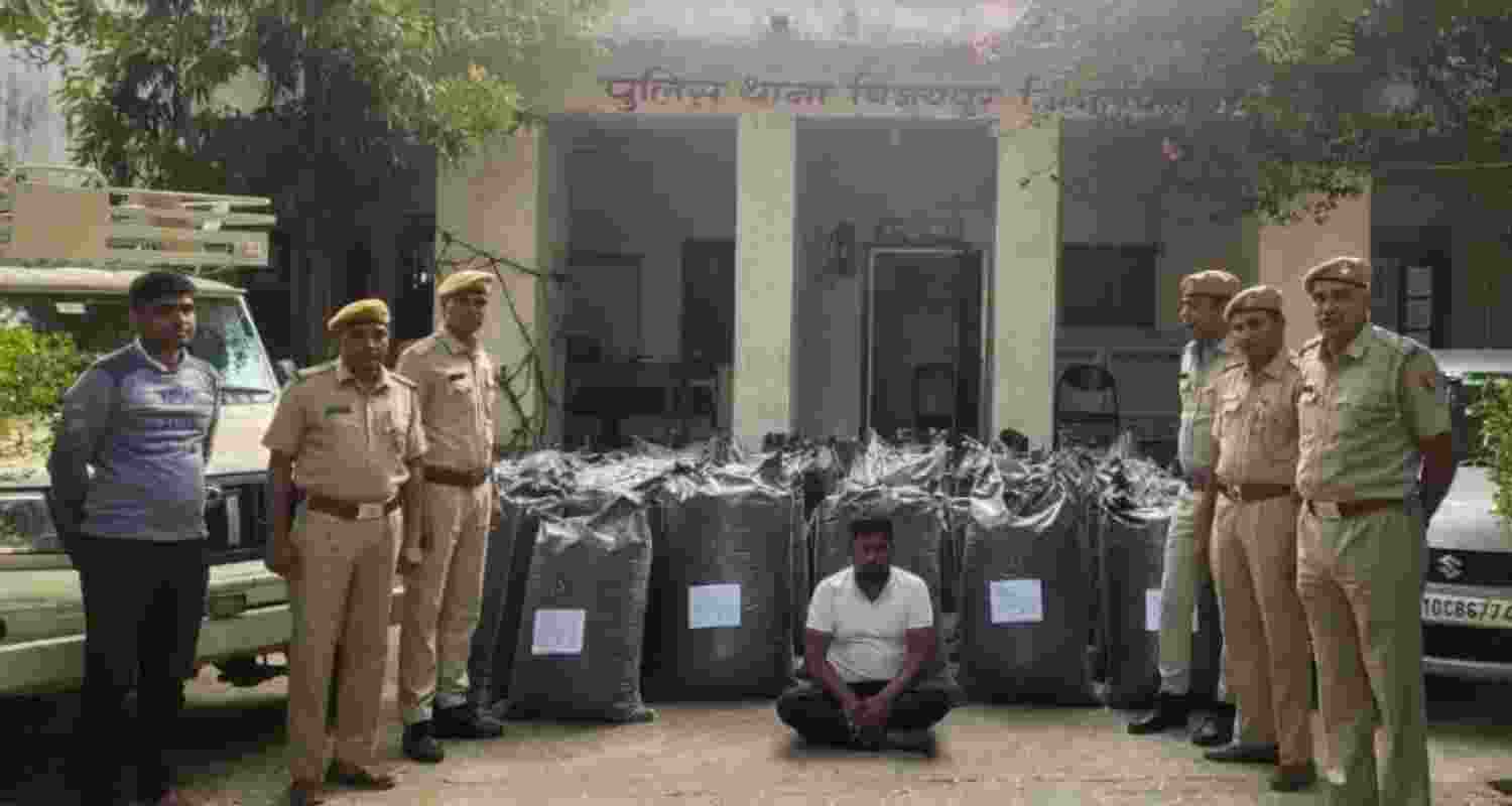 Image of the Confiscated Opium Poppy Powder and the smuggler who was caught, shared by Chittorgarh police on X.